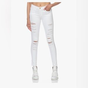 Frame le skinny de Jeanne. Super skinny stretch style, white distressed jeans.